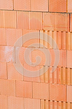 New orange brick wall background. House building worker concept