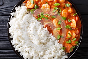 New Orleans gambo with shrimps and sausage close-up in a plate. photo