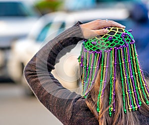 New Orleans, LA - February 9, 2016: Masked people along Mardi Gras Parade in Bourbon Street. Mardi Gras is the biggest celebration