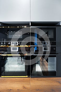 New ovens in household appliance section in store close up