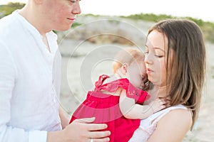 New parents with sleeping baby outdoors