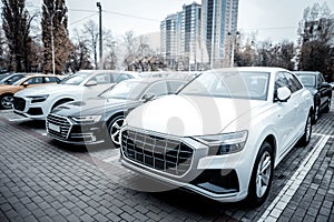 New passenger cars of corporate company standing outside