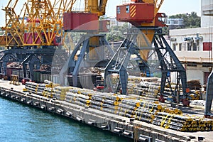 New pipes in the industrial port, cargo cranes and infrastructure