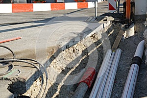 New pipes laid in a civil engineering shaft in the street with vertical and horizontal barrier planks