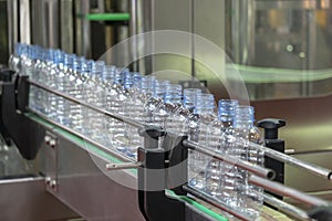 The new plastic bottles in the conveyor belt