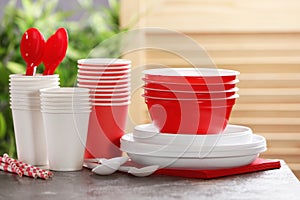 New plastic dishware on table against blurred background