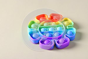 New popular silicone colorful antistress pop it toy for child on light background. Simple dimple. Copy space.