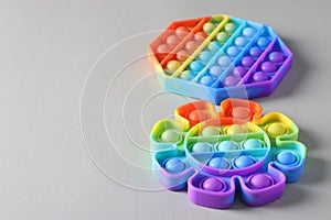 New popular silicone colorful antistress pop it toys for child on light background. Simple dimple. Copy space