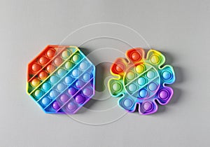 New popular silicone colorful antistress pop it toys for child on light background. Simple dimple. Top view