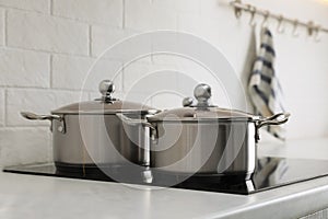 New pots on cooktop in kitchen