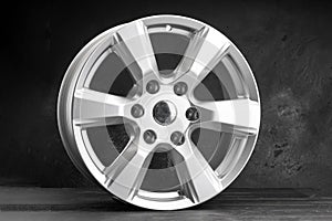 a new powerful six-spoke alloy wheel in silver color on a dark textured background. auto parts for SUVs and crossovers.