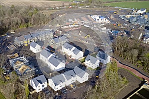 New private housing development construction in rural countryside aerial view
