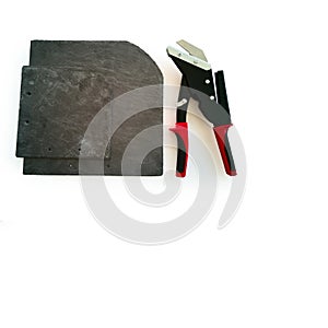 New professional tool,slate cutter,black red handles,cut on white,sheets of natural slate for exterior walls,copy space