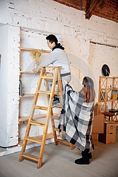 New property owners, young couple moving to new home, apartment, look happy