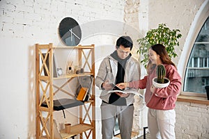 New property owners, young couple moving to new home, apartment, look happy