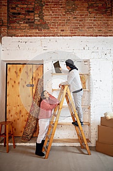 New property owners, young couple moving to new home, apartment, look happy