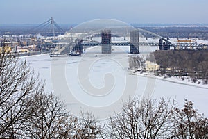 New railway bridge and frozen river Dnieper photo