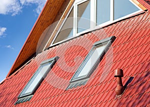 New red metal roof with windows skylights and ventilator for heat controlÃÅ½ photo