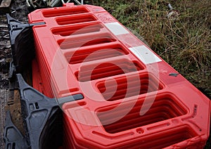 New red plastic temporary fence barriers stacked in a pile