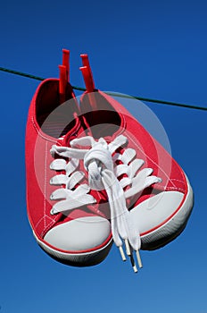 New red sneakers on washing line