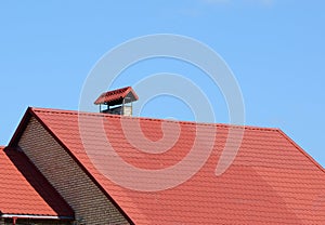 New red tiled roof with metal chimney house roofing construction exterior. Roofing construction.