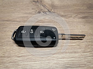 New remote car key fob on the wooden background locksmith service.- Image