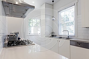 New renovated crisp white galley style kitchen photo