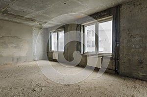 New residential apartment without finishing in modern home. Concrete walls and Communications