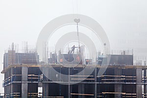 A new residential building under construction in the morning mist.