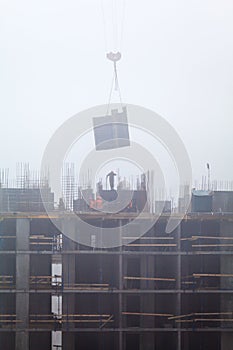 A new residential building under construction in the morning mist.