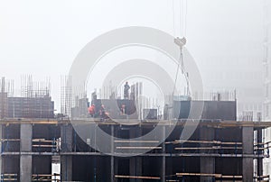 A new residential building under construction in the morning mist.