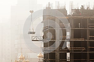 A new residential building under construction in the morning mist.