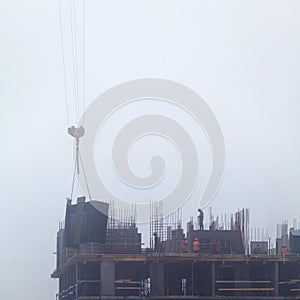 A new residential building under construction in the morning mist.