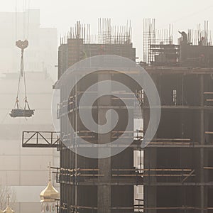 A new residential building under construction in the morning mist.