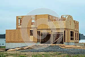 New residential construction home framing against a blue sky