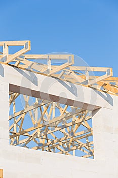 New residential construction home framing against a blue sky