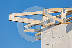 New residential construction home framing against a blue sky