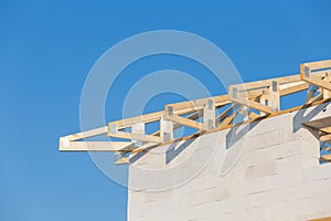 New residential construction home framing against a blue sky