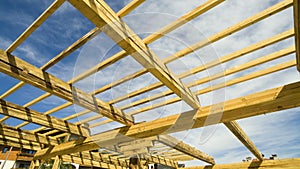 New residential construction house framing against a blue sky