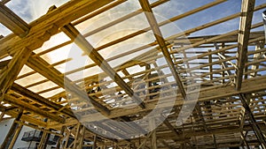 New residential construction house framing against a sunset