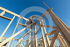 New residential construction of wooden frame house and worker. Roofing construction. Wooden construction. Construction