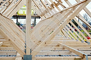 New residential home construction with roof framing joist against the sky