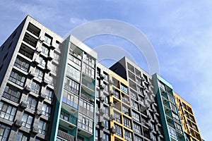 New residential multi-apartment multi-storey modern building in bright sunlight against the backdrop of a clear blue sky