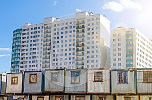 New residential multi-storey buildings, before them barracks for builders trailers. The concept of urbanization, contrast.