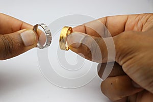 New rings of silver and gold held in the hand on a white background