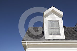 New Roof of House and Windows Against Deep Blue Sky