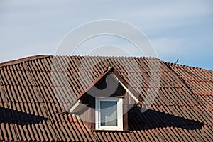 New roofing construction with attic skylights, rain gutter system, roof windows and roof protection from snow board