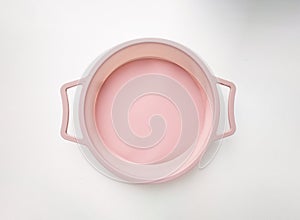 New round silicone baking dish with handles isolated on white background.