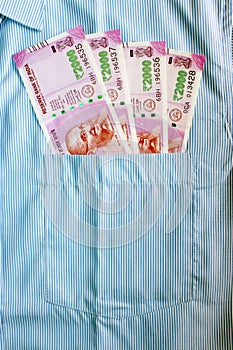 New 2000 rupee notes in an Indian mans shirts front pocket.