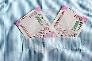 New 2000 rupee notes in an Indian mans shirts front pocket.